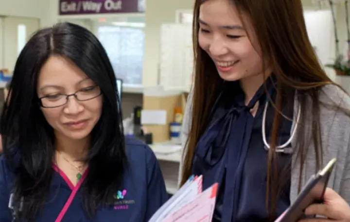 Two staff reviewing papers