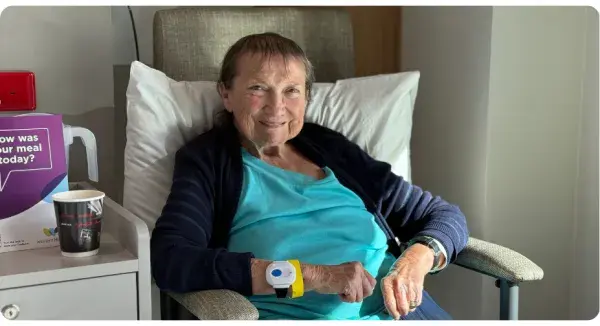 Woman smiling in chair.
