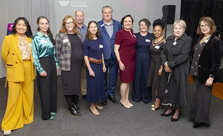 Eleven people smiling at the camera at awards presenation