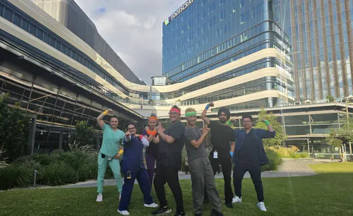 Staff at Western Health posing with headbands in front of Footscray Hospital.