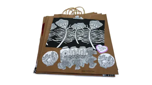 five bags placed on top of each other show the designs created by children